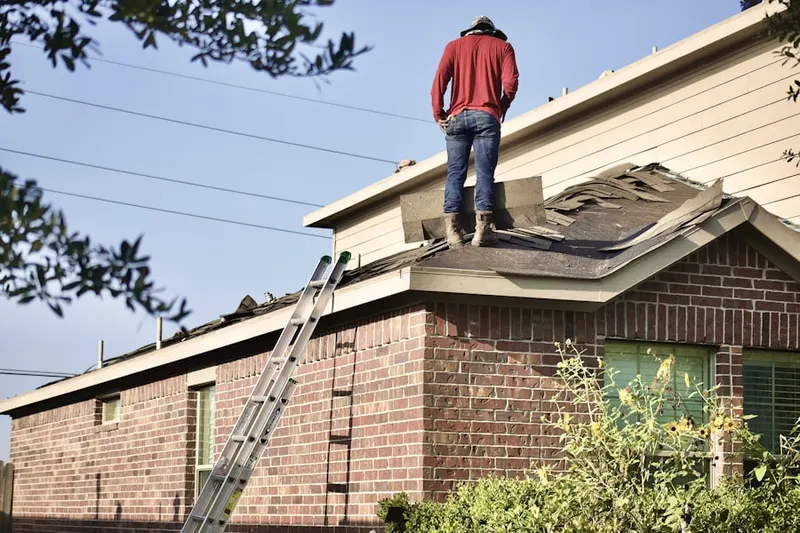 Professional roofer working on a residential roof in Orangetree